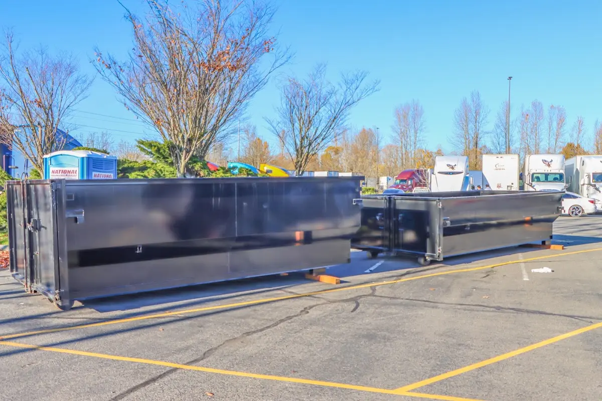 Professional dumpster rental service with roll-off container on residential driveway in Silverdale
